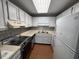 Well-lit kitchen with white cabinets, modern appliances, and a decorative backsplash at 5001 Little River Rd. # E-312, Myrtle Beach, SC 29577