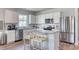 Modern kitchen with stainless steel appliances, white cabinets and a large granite island at 5012 Neverland Ct, Myrtle Beach, SC 29588