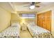 Comfortable bedroom with twin beds, ceiling fan, and beach-themed decor at 5507 N Ocean Blvd. # 304, Myrtle Beach, SC 29577