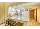 Open-concept kitchen bar with seating, granite countertops, stainless steel appliances, and convenient access to the dining area at 5507 N Ocean Blvd. # 304, Myrtle Beach, SC 29577