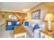 Bright living room with tile flooring, comfortable sofas, and staircase to the upper level at 5507 N Ocean Blvd. # 304, Myrtle Beach, SC 29577