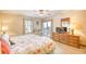 Bright main bedroom features a ceiling fan, a dresser and access to the balcony at 5507 N Ocean Blvd. # 304, Myrtle Beach, SC 29577