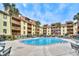 Outdoor pool surrounded by palm trees and lounge chairs at the resort-style condo complex, perfect for relaxation at 5507 N Ocean Blvd. # 304, Myrtle Beach, SC 29577