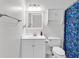 A bright bathroom features a vanity with storage, and a shower with decorative curtain at 5750 Oyster Catcher Dr. # 533, North Myrtle Beach, SC 29582