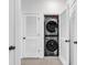 A convenient laundry closet is equipped with a stacked washer and dryer for easy laundry at 5750 Oyster Catcher Dr. # 533, North Myrtle Beach, SC 29582