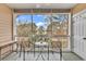 Cozy screened porch with seating and views of the natural landscape at 5750 Oyster Catcher Dr. # 533, North Myrtle Beach, SC 29582