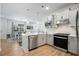 Modern kitchen with stainless steel appliances, pendant lights, white cabinets, and an adjoining dining area at 5987 Tramonto St., Myrtle Beach, SC 29577