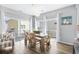 Bright dining area features a wooden table, statement lighting, and sliding glass doors to the outdoor deck at 6001- 1084 S Kings Highway, Myrtle Beach, SC 29575