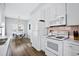 Charming kitchen featuring white appliances, a light backsplash, and an adjacent dining area at 6001- 1084 S Kings Highway, Myrtle Beach, SC 29575