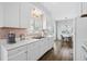 Well-lit kitchen with white cabinets, stainless steel sink, and complementary hardware at 6001- 1084 S Kings Highway, Myrtle Beach, SC 29575