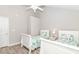 Bright bedroom features two beds, wood floor, and a ceiling fan at 6001-1383 S Kings Hwy., Myrtle Beach, SC 29575
