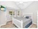 Bright bedroom features a flat screen television, a large window, and coastal-themed bedding at 6001-1383 S Kings Hwy., Myrtle Beach, SC 29575