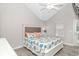 This bright bedroom has a vaulted ceiling, an upholstered headboard, and coastal decor at 6001-1383 S Kings Hwy., Myrtle Beach, SC 29575