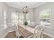 Bright dining room with a wooden table, white chairs, and ample natural light, creating a welcoming space at 6001-1383 S Kings Hwy., Myrtle Beach, SC 29575