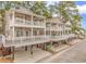 Charming beach homes featuring multiple covered decks, offering beautiful outdoor living spaces and curb appeal at 6001-1383 S Kings Hwy., Myrtle Beach, SC 29575