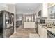 Open kitchen with stainless steel appliances, modern cabinets, and a view into the dining and living areas at 6001-1383 S Kings Hwy., Myrtle Beach, SC 29575