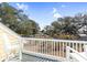 Enjoy neighborhood views from this charming balcony with white railings and Adirondack chairs at 6514 Anchors Bend Dr Sw, Ocean Isle Beach, NC 28469