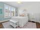 Bright bedroom featuring board and batten walls, a large window with shutters, and a full size bed at 6514 Anchors Bend Dr Sw, Ocean Isle Beach, NC 28469