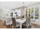 Elegant dining area with a modern chandelier and bright natural lighting at 6514 Anchors Bend Dr Sw, Ocean Isle Beach, NC 28469