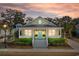 Inviting yellow home with a spacious front porch, perfect for relaxing evenings at 6514 Anchors Bend Dr Sw, Ocean Isle Beach, NC 28469