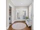 Hallway has a hardwood floor, a shuttered window, and a door leading to the laundry room at 6514 Anchors Bend Dr Sw, Ocean Isle Beach, NC 28469