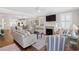 Bright living room with a fireplace, plush seating, and elegant decor at 6514 Anchors Bend Dr Sw, Ocean Isle Beach, NC 28469