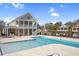 Large swimming pool with sundeck and covered patio in a vibrant community setting at 6514 Anchors Bend Dr Sw, Ocean Isle Beach, NC 28469