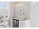 Stylish wet bar featuring a sink, stainless steel refrigerator, light countertop and lighting fixture at 6514 Anchors Bend Dr Sw, Ocean Isle Beach, NC 28469