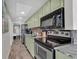 Galley kitchen features stainless steel appliances and marble countertops at 6804 N Ocean Blvd. # 1623, Myrtle Beach, SC 29572