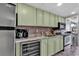 Kitchen with green cabinets, stainless steel appliances, and island at 6804 N Ocean Blvd. # 1623, Myrtle Beach, SC 29572