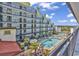 Exterior view of a blue condo with a pool surrounded by palm trees and lounge chairs at 6804 N Ocean Blvd. # 1623, Myrtle Beach, SC 29572