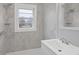Well-lit bathroom features marble-patterned walls, a single window, and a white vanity at 708 Bobby L. Davis Blvd., Marion, SC 29571