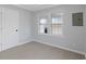 Bedroom with light gray walls, door, two windows and light colored vinyl plank floors at 708 Bobby L. Davis Blvd., Marion, SC 29571