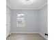 Bright bedroom with panelled walls, ceiling fan, updated flooring, and a large window at 708 Bobby L. Davis Blvd., Marion, SC 29571