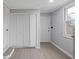Hallway with light gray walls, closet, a window and light colored vinyl plank floors at 708 Bobby L. Davis Blvd., Marion, SC 29571