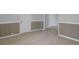 Neutral hallway boasts clean white trim, light hardwood flooring, and classic wall panels at 708 Bobby L. Davis Blvd., Marion, SC 29571
