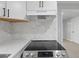 Modern kitchen showcasing a stainless steel stove top, quartz countertops, and marble backsplash at 708 Bobby L. Davis Blvd., Marion, SC 29571