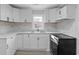 Modern kitchen with white cabinets, marble backsplash, and stainless steel appliances at 708 Bobby L. Davis Blvd., Marion, SC 29571