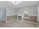 Bright living room with a decorative fireplace, wainscoting, and new flooring at 708 Bobby L. Davis Blvd., Marion, SC 29571