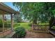 Inviting backyard featuring a wooden deck, lush lawn and mature trees at 906 Plantation Dr., Surfside Beach, SC 29575