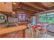 Bright kitchen featuring classic wood cabinets and a cozy breakfast nook with a scenic window view at 906 Plantation Dr., Surfside Beach, SC 29575