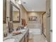 Bathroom features a double sink vanity, granite counters, soaking tub, and glass shower at 9547 Edgerton Dr. # Ph1005, Myrtle Beach, SC 29572
