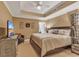 Comfortable bedroom boasts a tray ceiling, TV, and stylish decor at 9547 Edgerton Dr. # Ph1005, Myrtle Beach, SC 29572