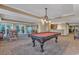 Community game room features a billiards table, seating, and a kitchenette at 9547 Edgerton Dr. # Ph1005, Myrtle Beach, SC 29572