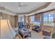 Cozy living room featuring comfortable seating, a ceiling fan, and access to the balcony at 9547 Edgerton Dr. # Ph1005, Myrtle Beach, SC 29572