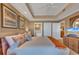Spacious main bedroom boasts tray ceiling, stylish decor, and ensuite bathroom access at 9547 Edgerton Dr. # Ph1005, Myrtle Beach, SC 29572