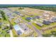 Aerial view of the neighborhood showcasing community layout, lush landscaping, pool, and convenient parking at 994 Oak Hollow St., Longs, SC 29568