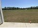 Large open backyard view overlooking a pond and treeline, showcasing a spacious outdoor area at 994 Oak Hollow St., Longs, SC 29568
