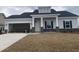 Charming single-story home with stone accents, an attached garage, and a well-maintained lawn at 994 Oak Hollow St., Longs, SC 29568