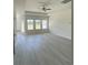 Bright, spacious living room with hardwood floors, abundant natural light, and modern ceiling fan at 994 Oak Hollow St., Longs, SC 29568